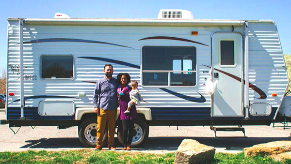 Carrie and Derek by the travel trailer