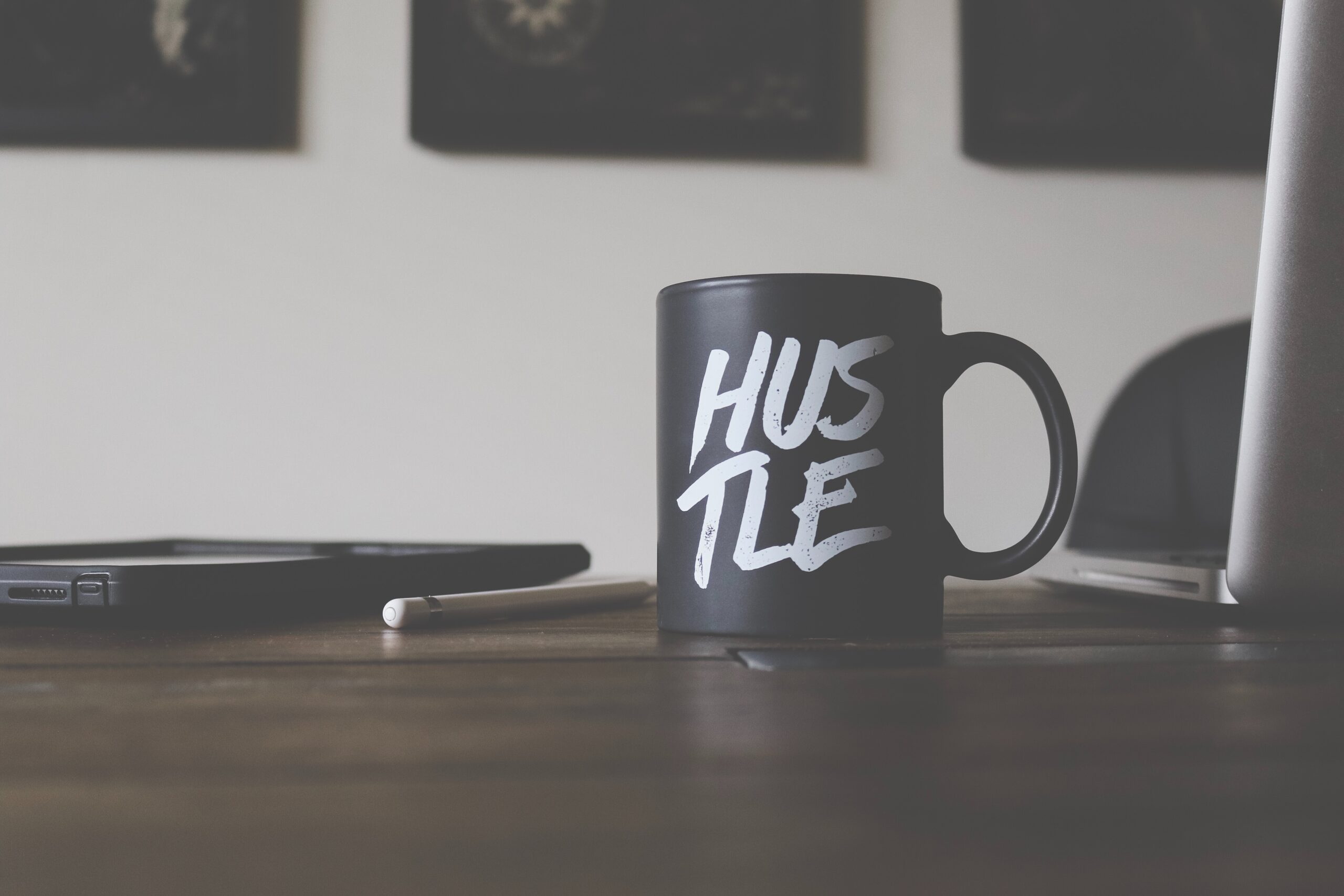 mug on a table that reads, "hustle"